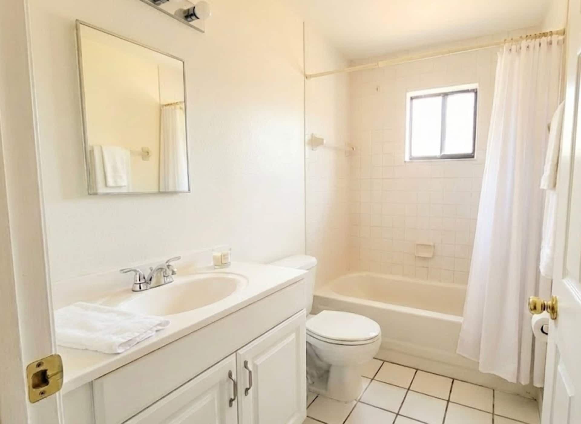 Full bathroom with tub and vanity