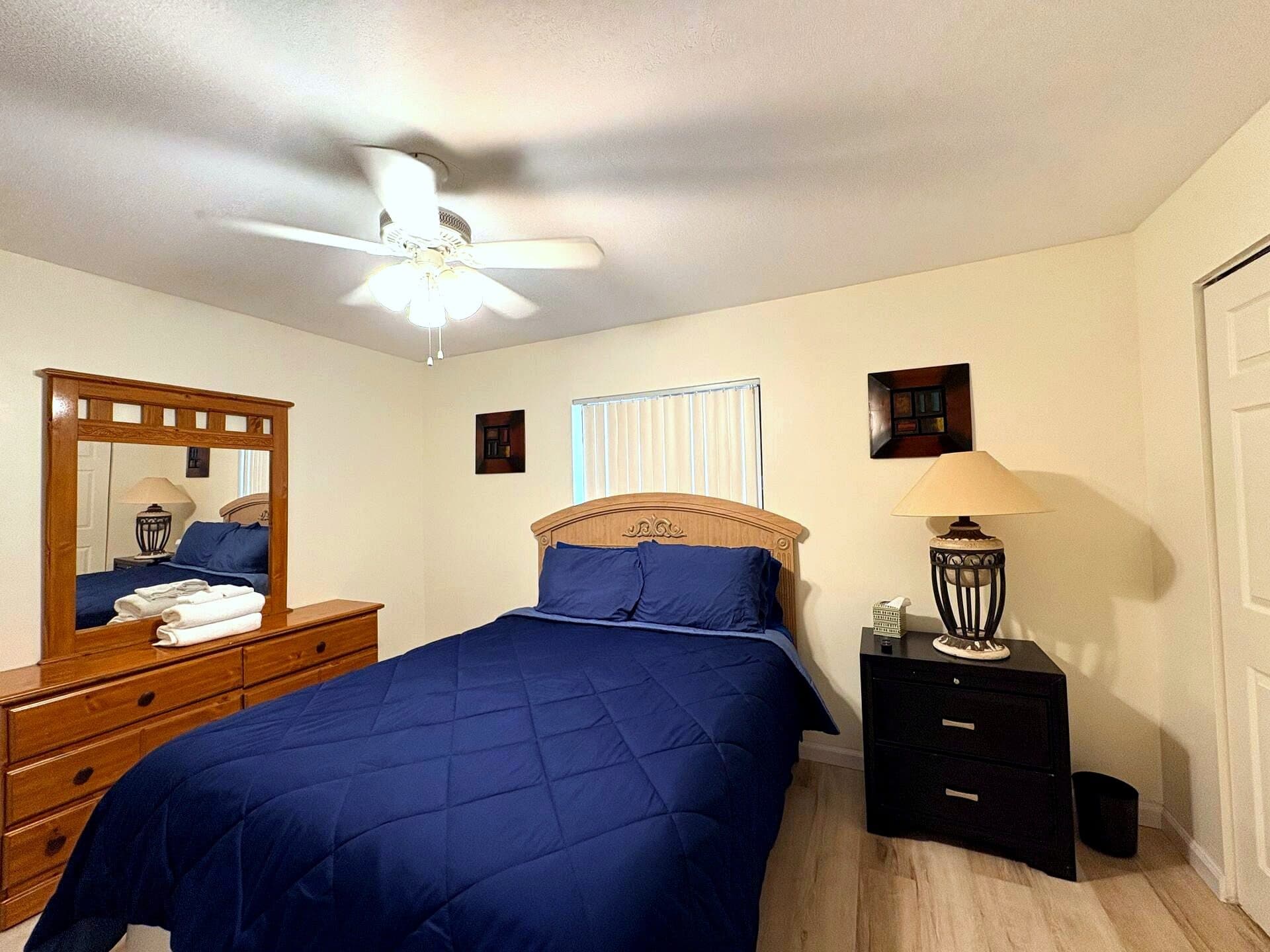 Primary bedroom with queen bed and ceiling fan