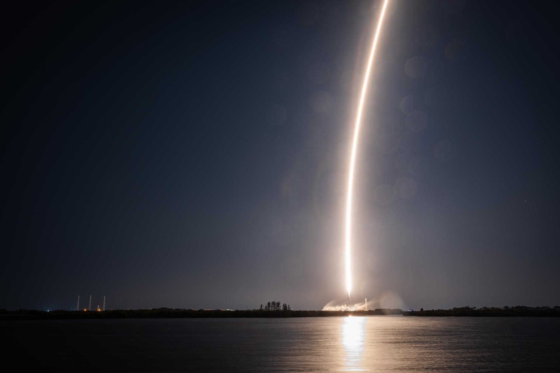 Rocket launch lighting up the night sky over the Space Coast